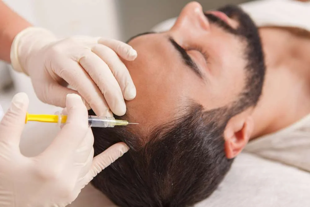 close up cosmetologist injecting vitamins scalp balding man